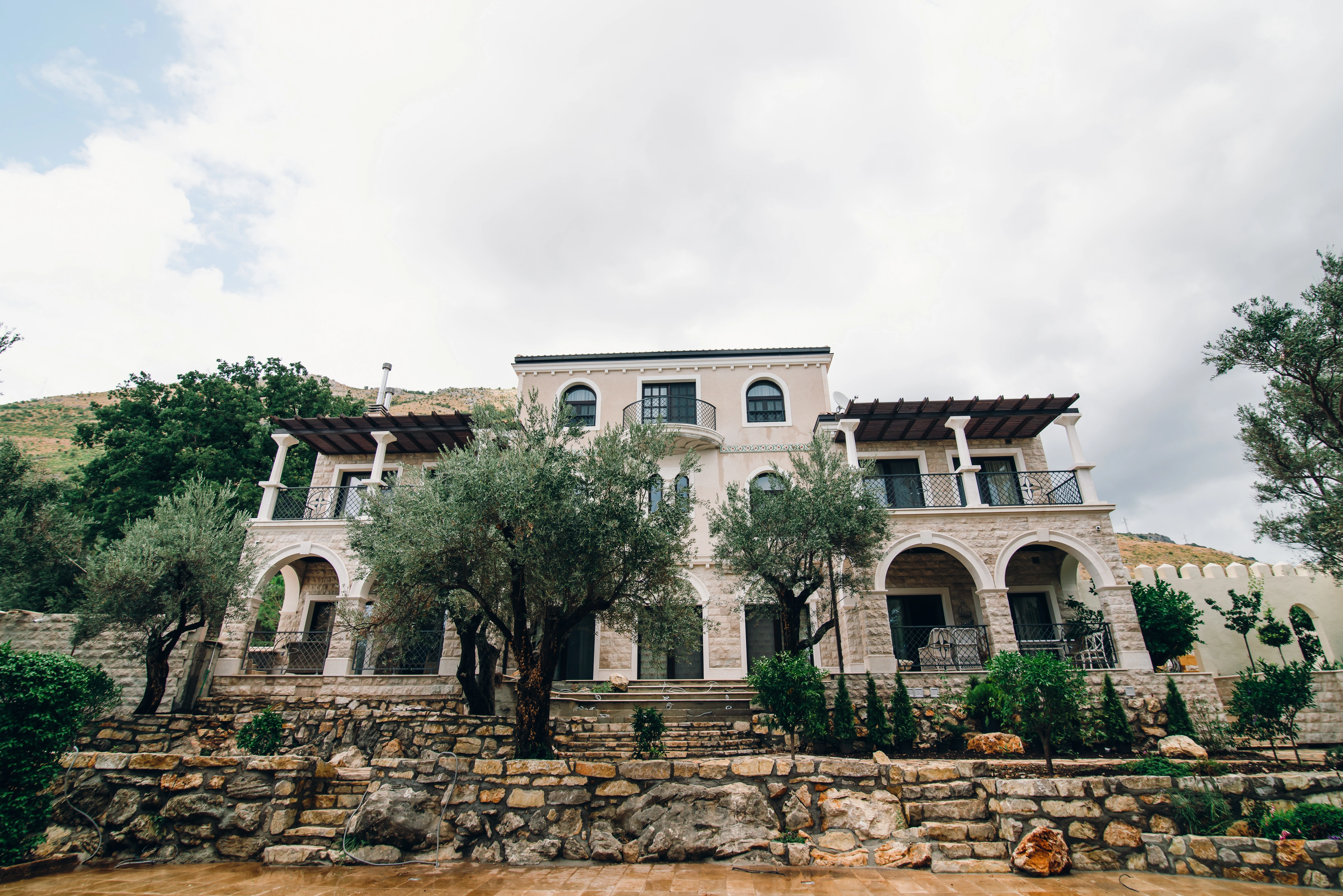 Sunlit Stone Façade with Wooden Shutters – Beautiful Villa Exterior in Montenegro